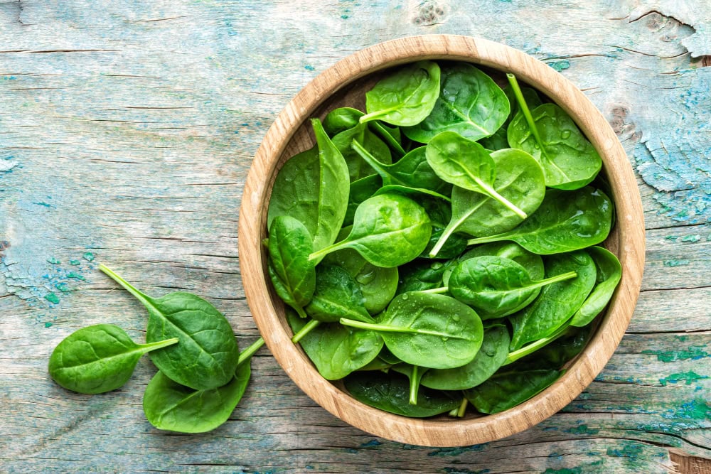 Fresh baby spinach leaves in bowl