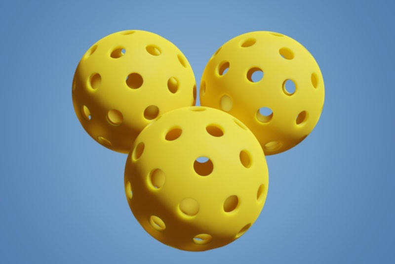 Pickleball three yellow sports balls