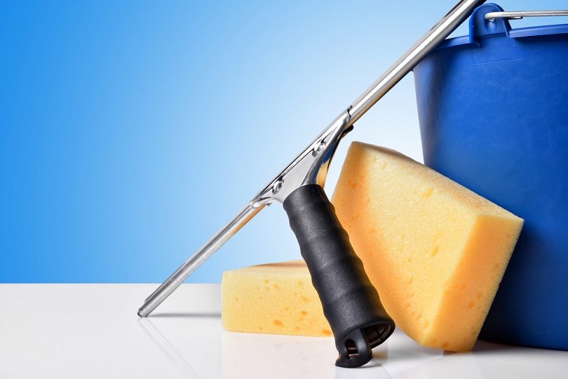 Window-cleaning-tools-on-white-table-squeegee_Davizro-Photography_shutterstock