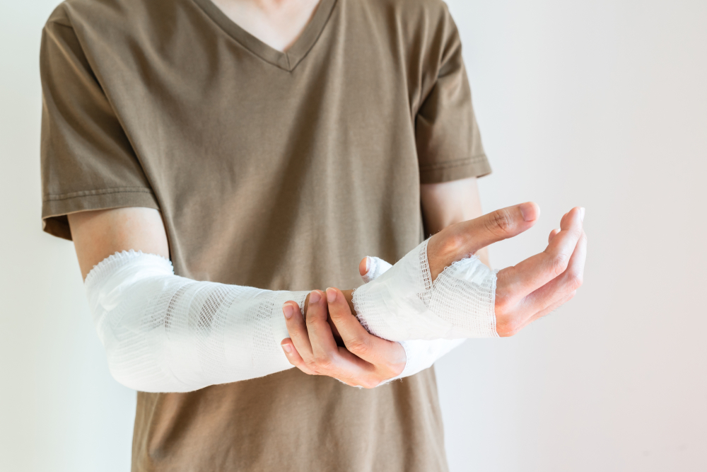 man with gauze bandage wrapped around his injured arms