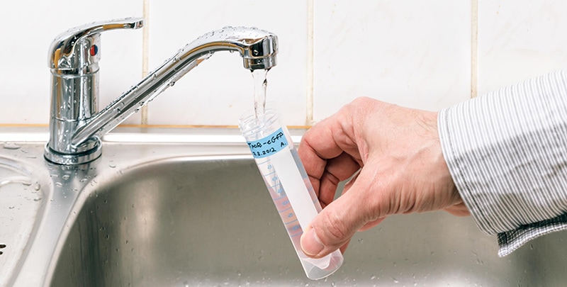 person testing tap water